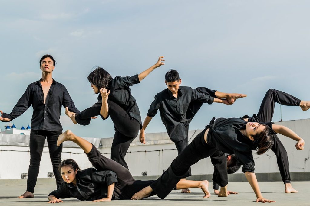 Energetic group performing synchronized martial arts on a rooftop.